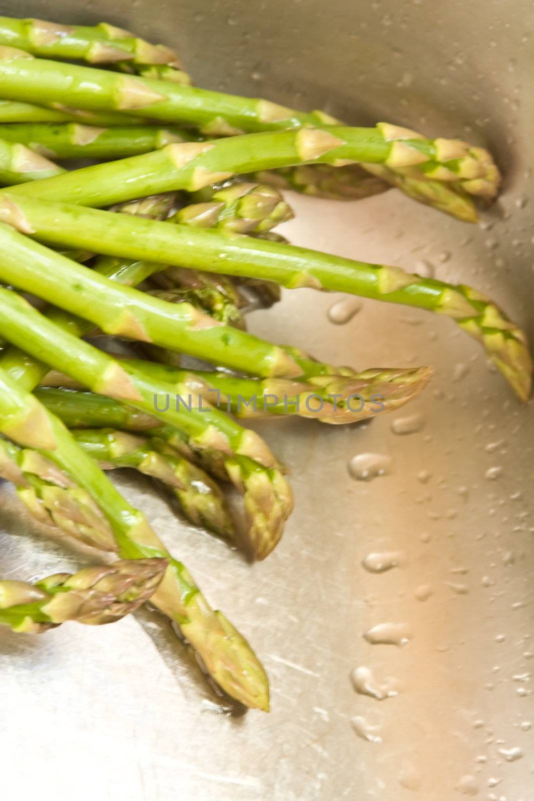washing asparagus shot with a macro lens getting ready for a healthy dinner
