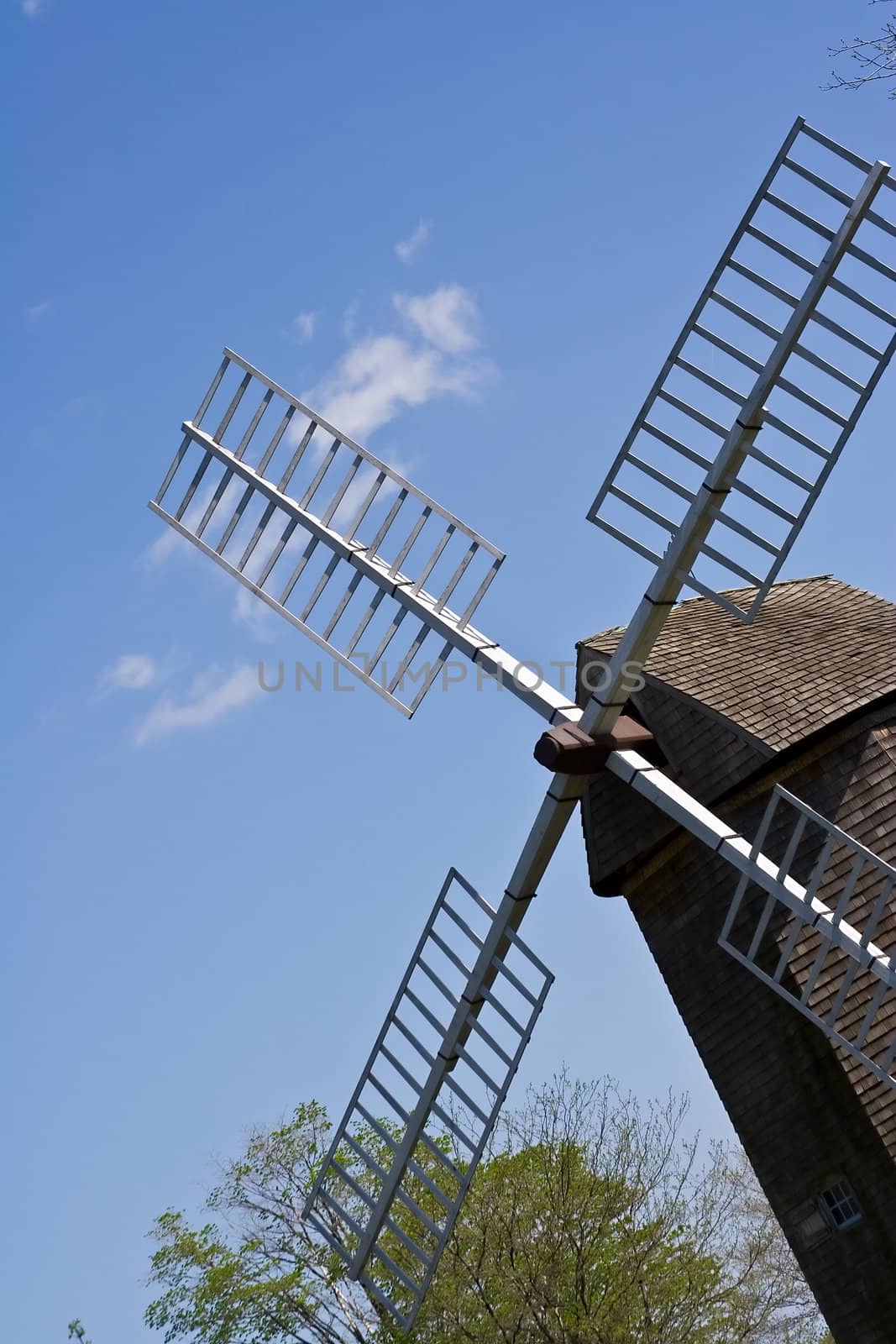 old windmill against a blue sky nice green background image