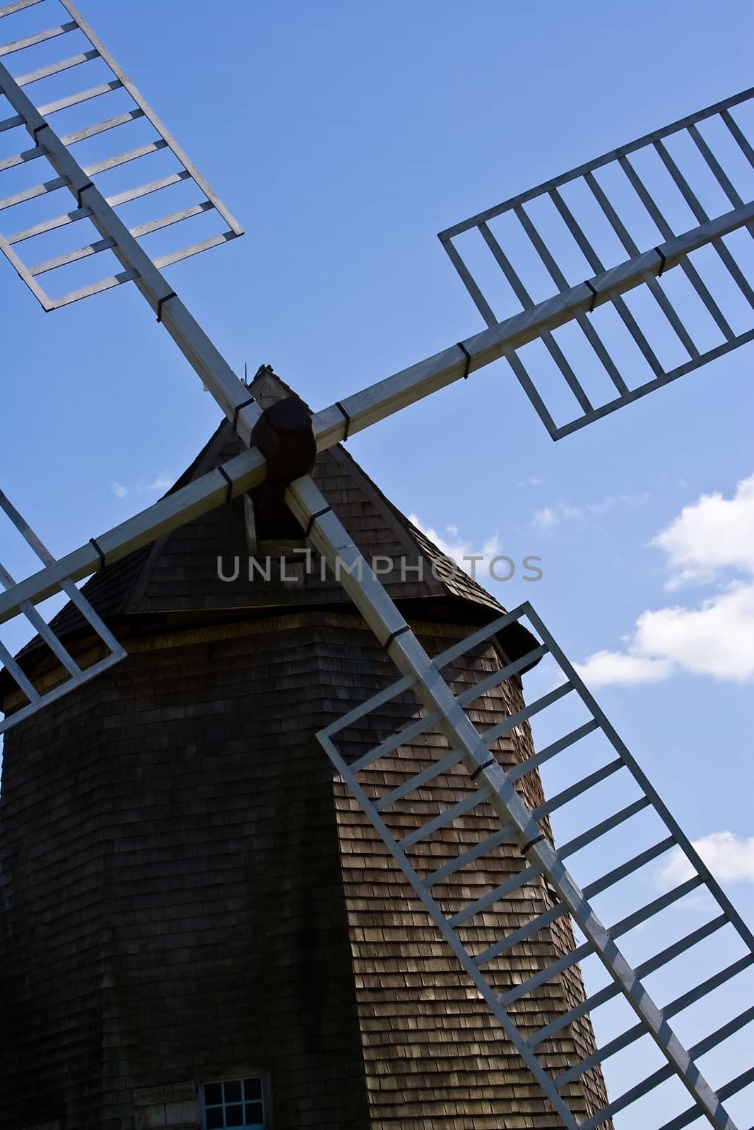 old windmill against a blue sky nice green background image