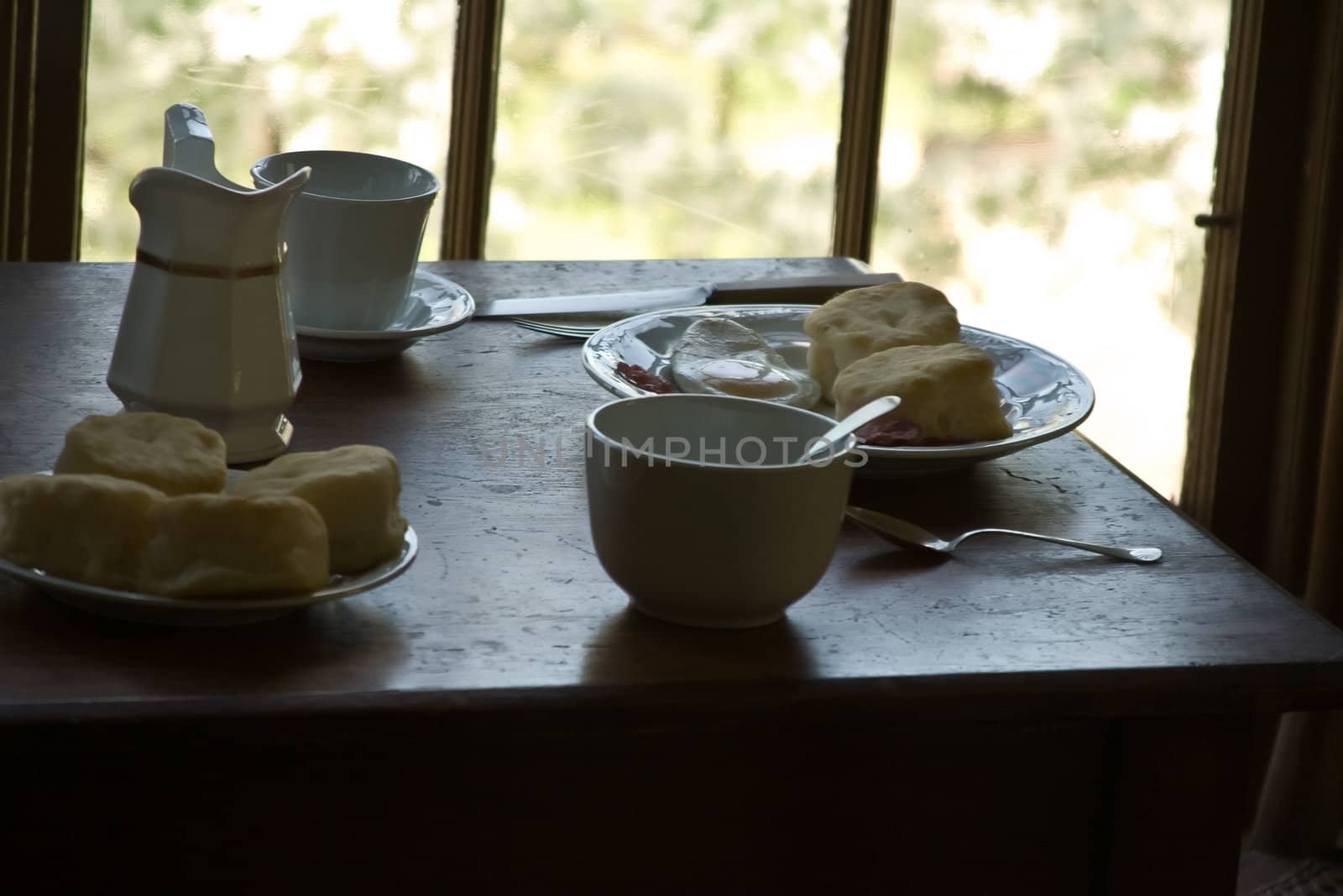 table all set for breakfast coffee biscuits and juice