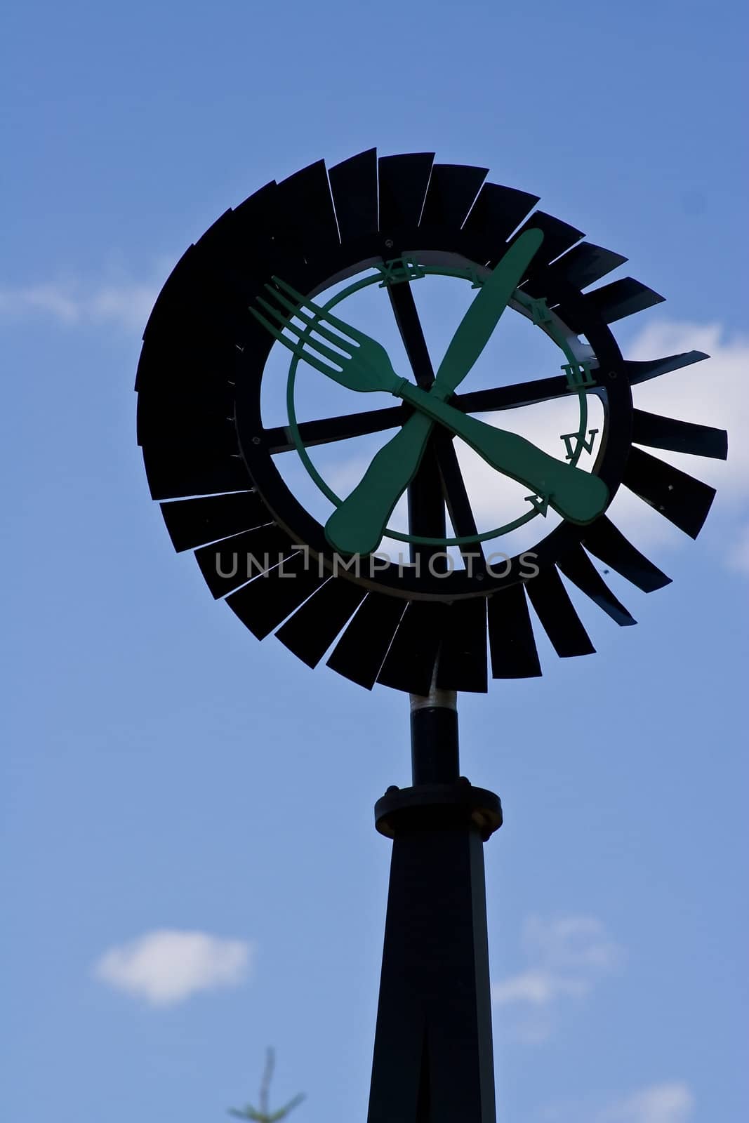 old windmill against a blue sky nice green background image