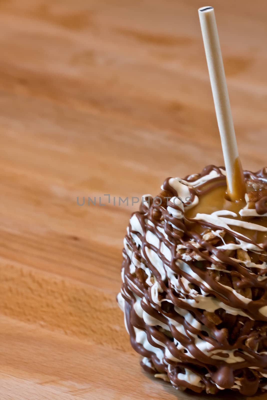 candy coated apple on a wood cutting board