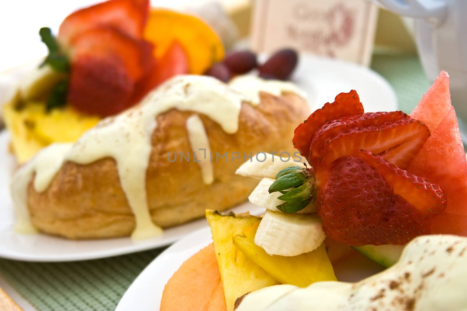 a light and healthy breakfast fresh fruit on white china