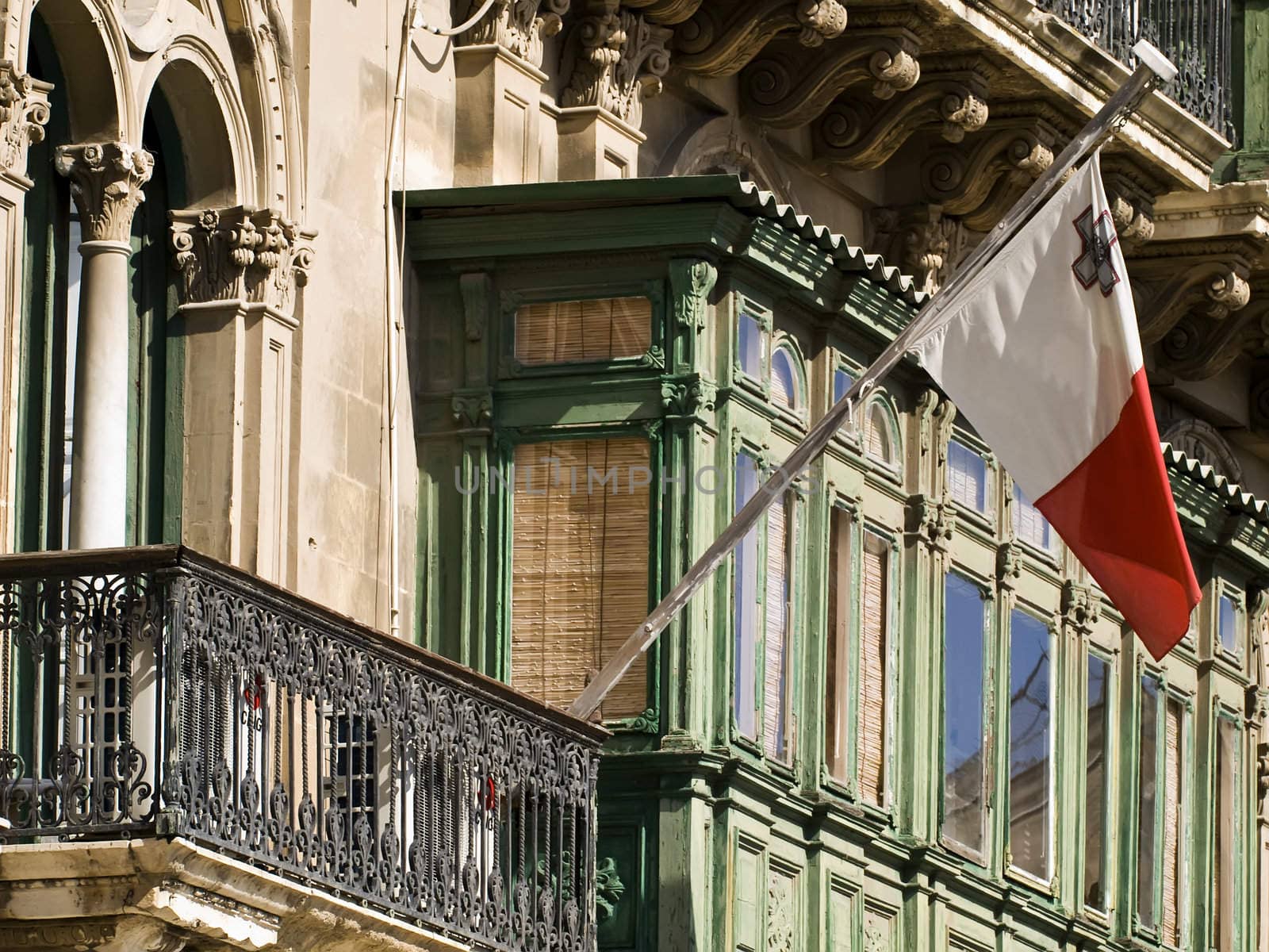 Malta flag on a typical Valletta facade with balcony
