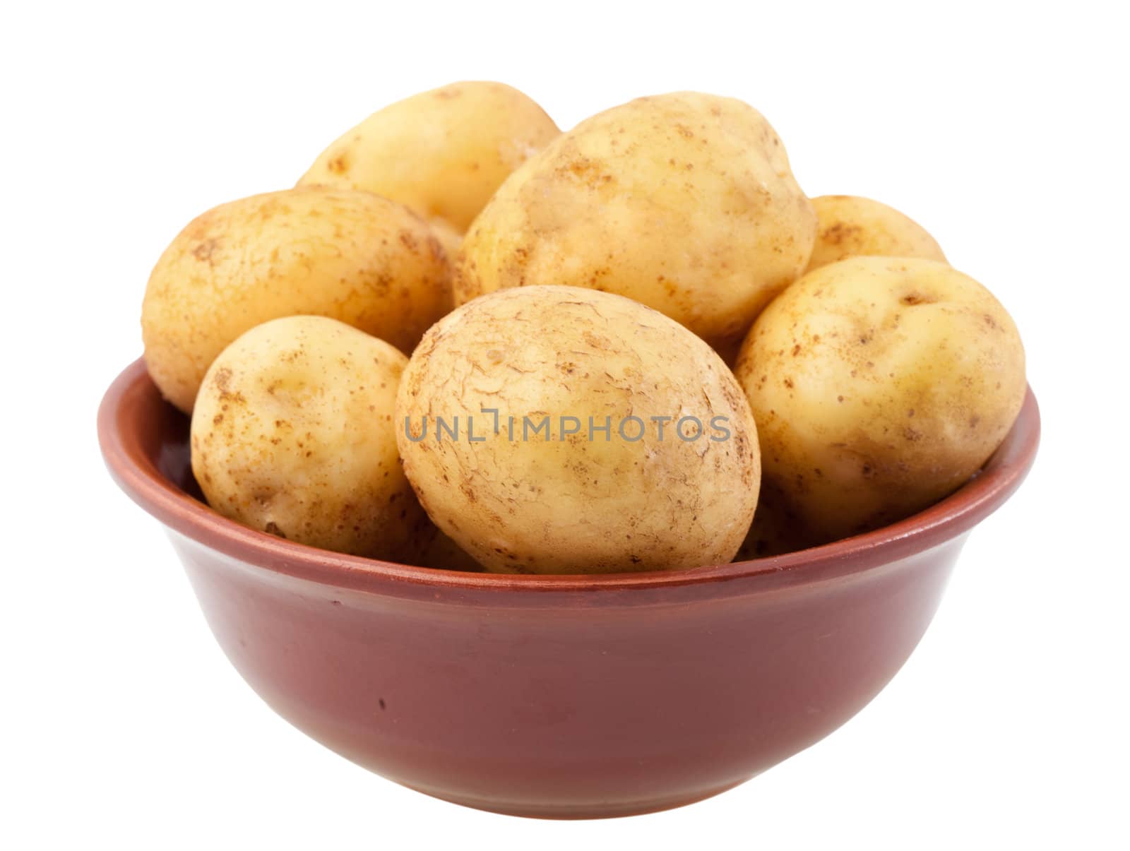Many young potatoes in a clay bowl isolated on white background