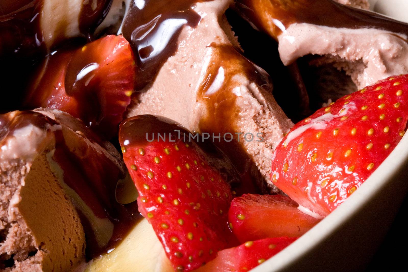 ice cream covered in chocolate shot close up dark background