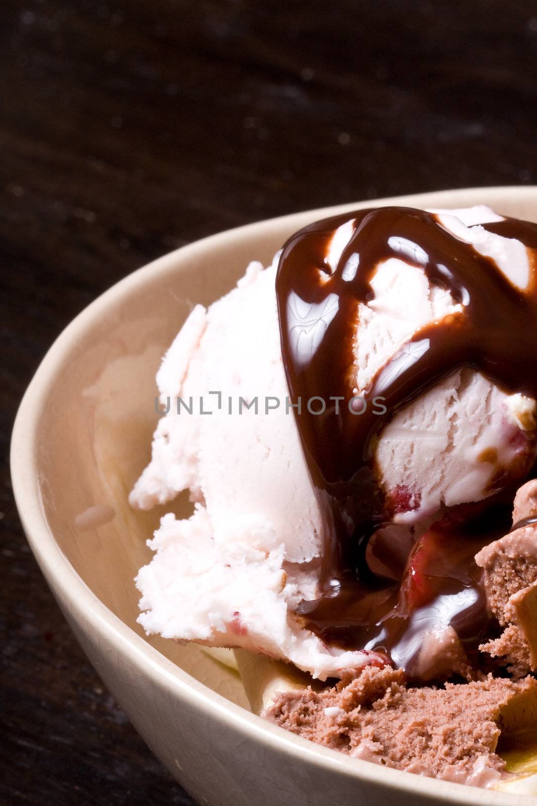 ice cream covered in chocolate shot close up dark background