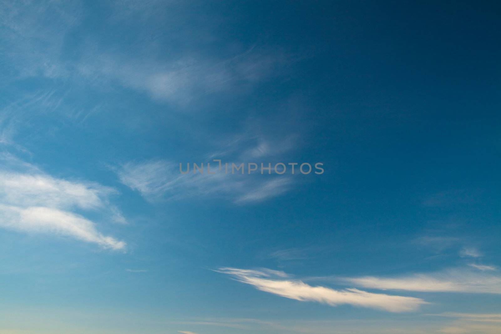 Large fragment of the sky with a few cirrus clouds. Photos shot with a polarizing filter. Abstract beautiful backdrop for any purpose