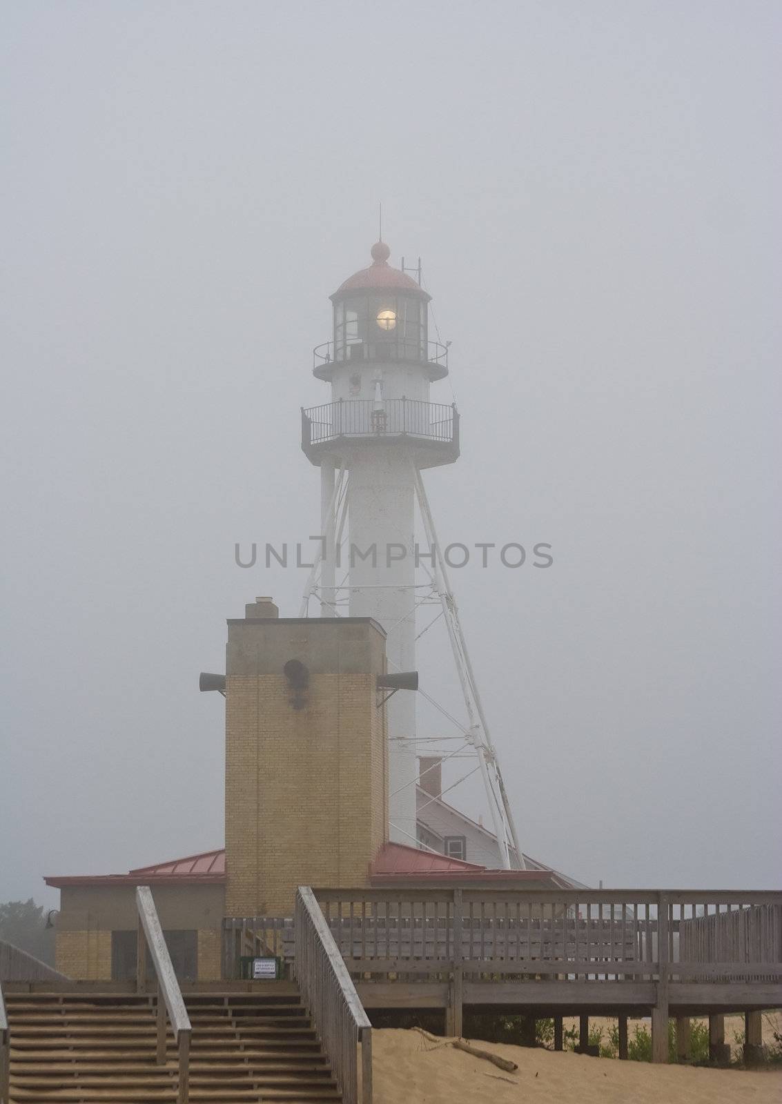 lighthouse in northern michigan on lake superior foggy and the light is working