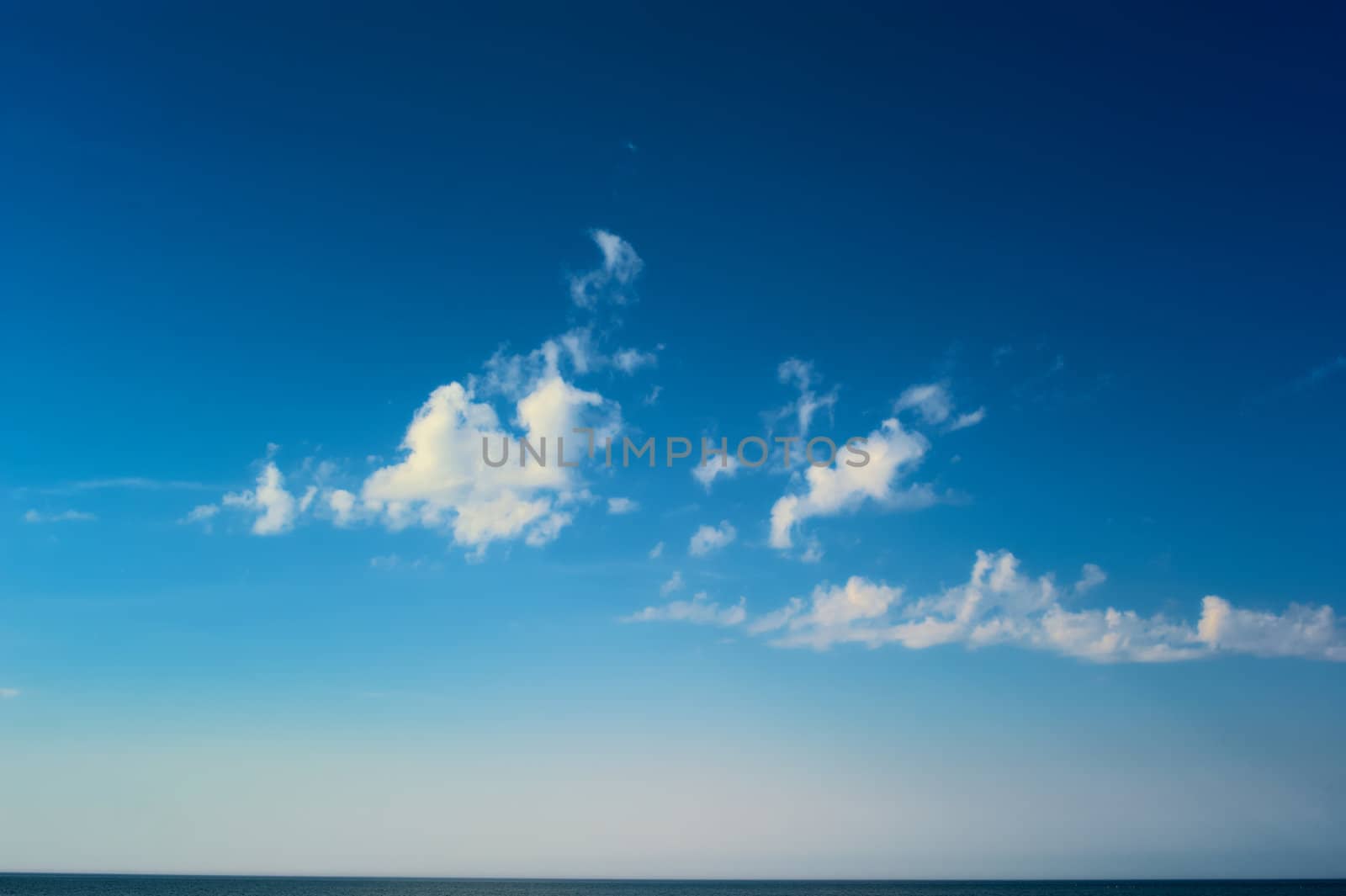 White clouds high above the sea surface