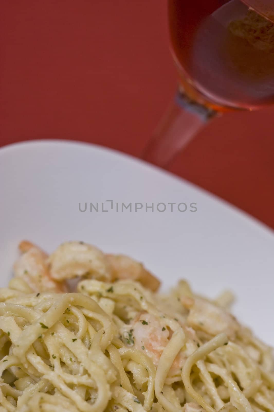 white plate full of shrimp pasta seasoned and hot