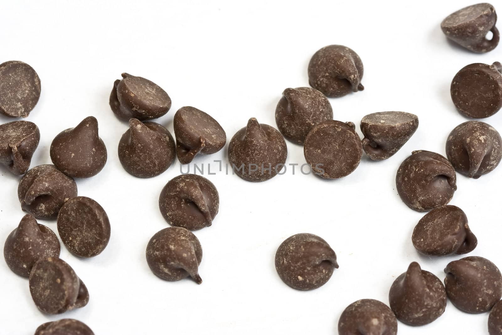 tasty chocolate chips on a white background