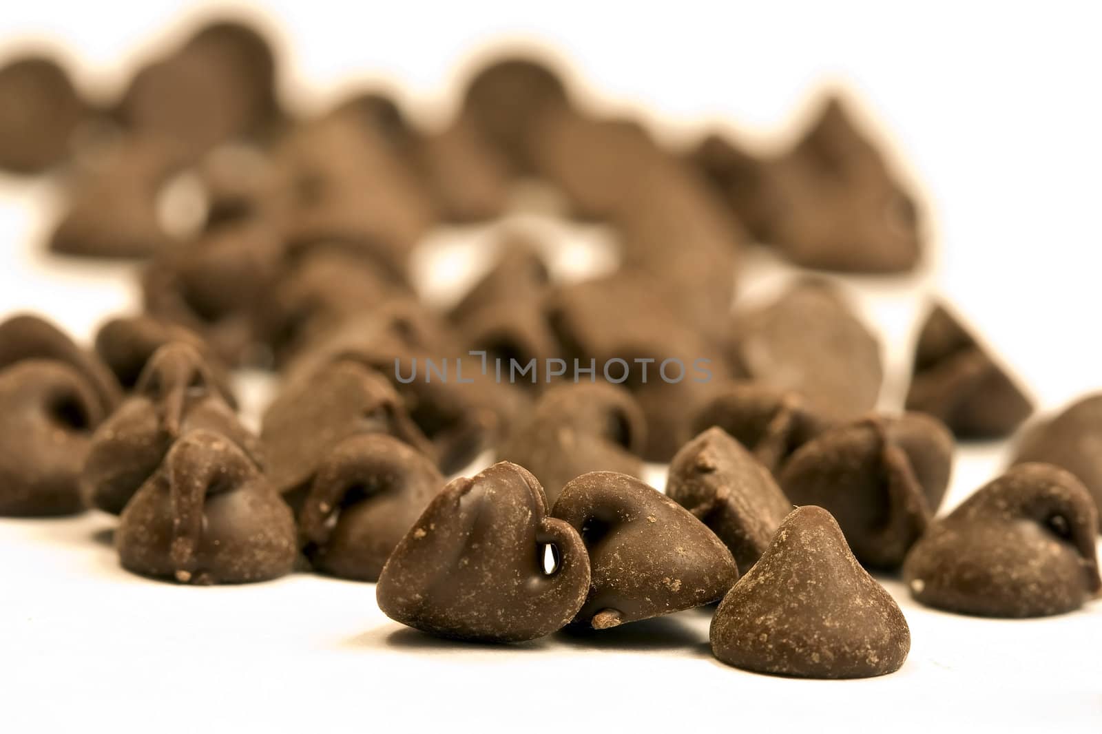 tasty chocolate chips on a white background