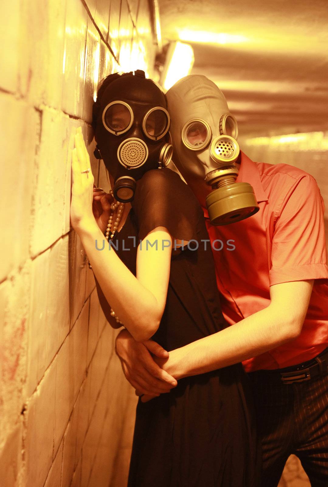 Married couple in gas masks in a tunnel