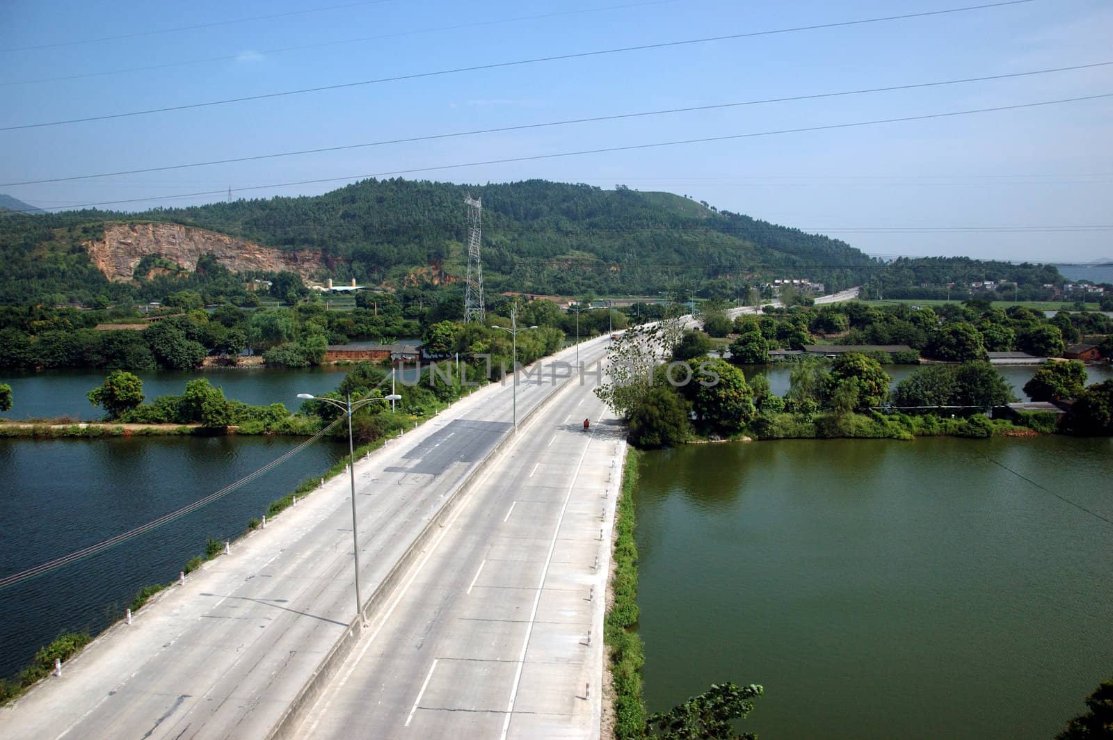 Chinese countryside, around town QingYuan in Guangdong province. General view with main road and lakes, hills.