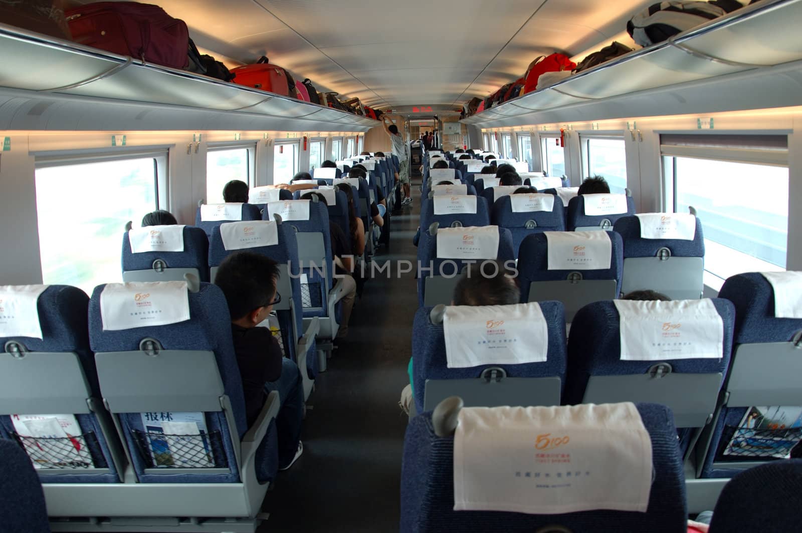 GUANGZHOU, CHINA - SEPTEMBER 29: China invests in fast and modern railway, trains with speed over 340 km/h. Passengers inside the train on the way from Guangzhou to Wuhan on September 29, 2010.