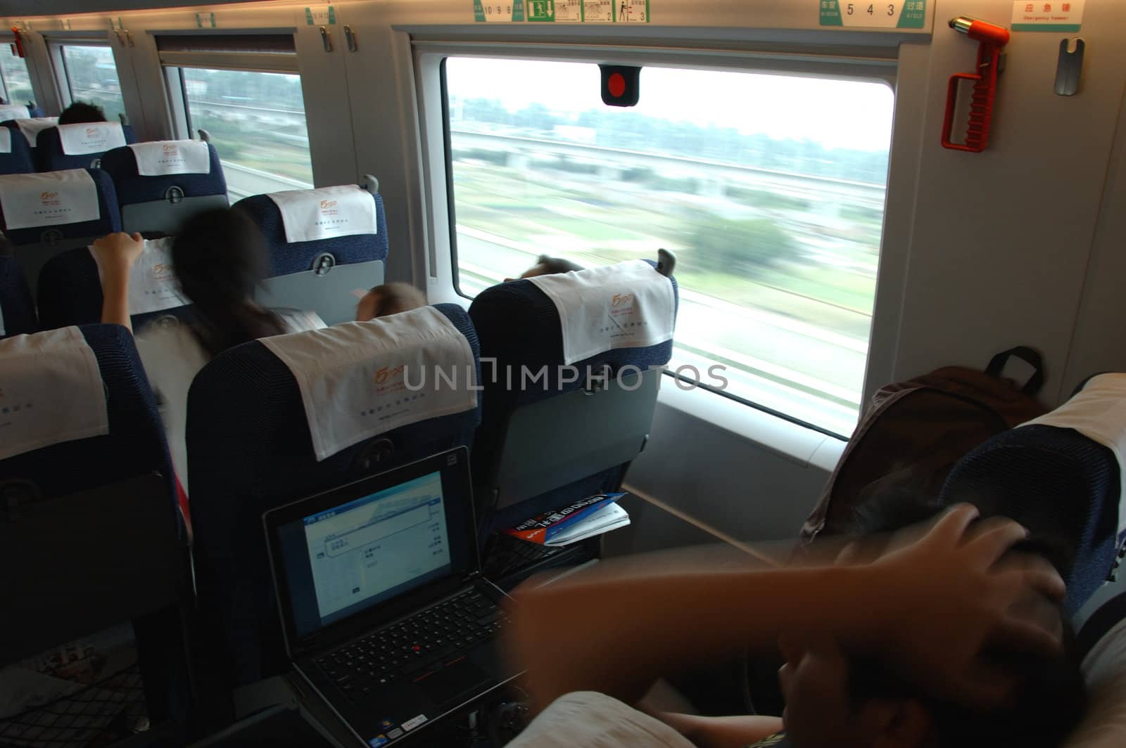 GUANGZHOU, CHINA - SEPTEMBER 29: China invests in fast and modern railway, trains with speed over 340 km/h. Passengers inside the train on the way from Guangzhou to Wuhan on September 29, 2010.