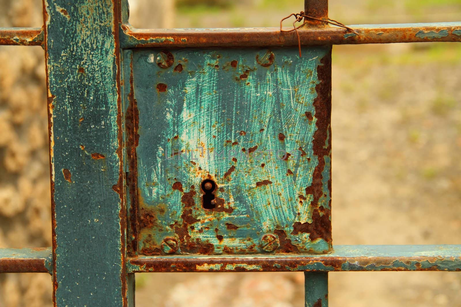 Detail of the lock and keyhole on an old gate.