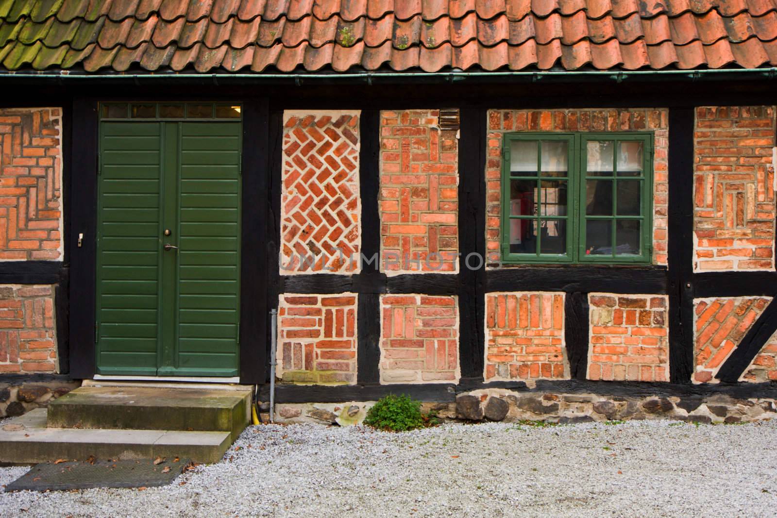 Entrance and window of a brick home