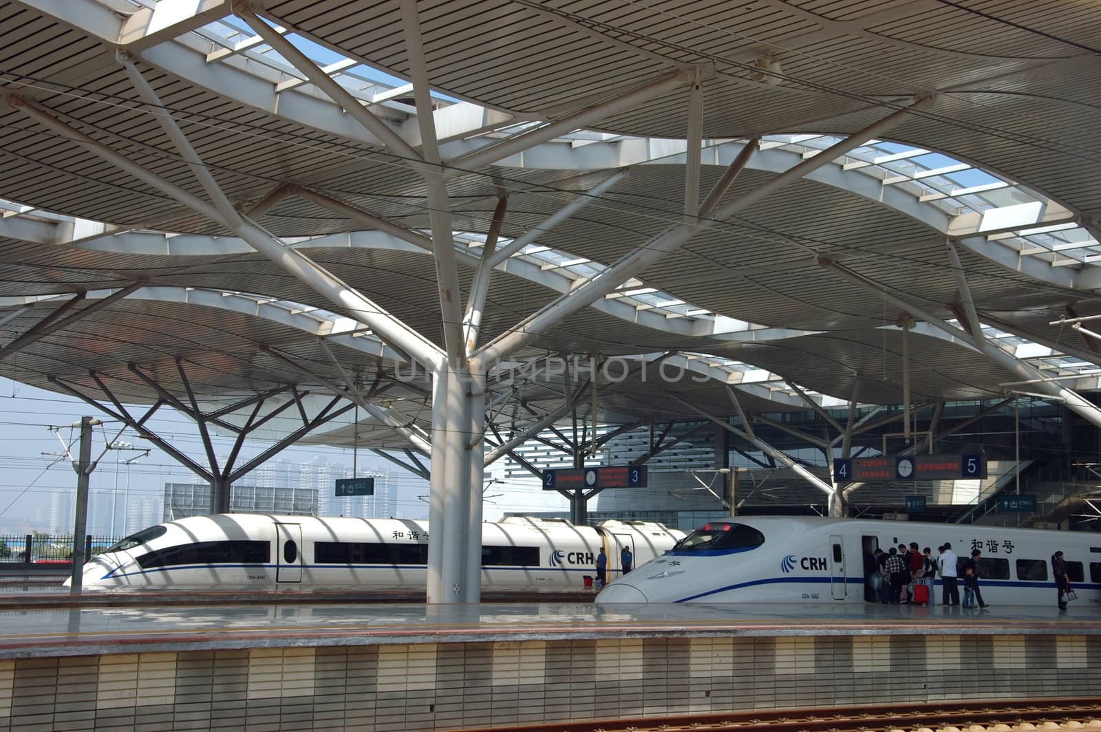 CHANGSHA - HUNAN, CHINA - OCTOBER 3: China invests in fast and modern railway, trains with speed over 340 km/h. Newly build station with trains on platforms on October 3, 2010 in Changsha.