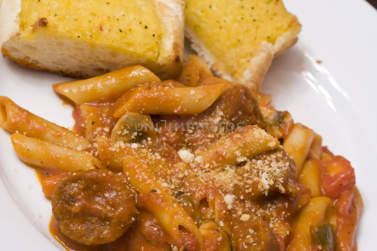 serving of penne spaghetti white dishes nice reddish colors