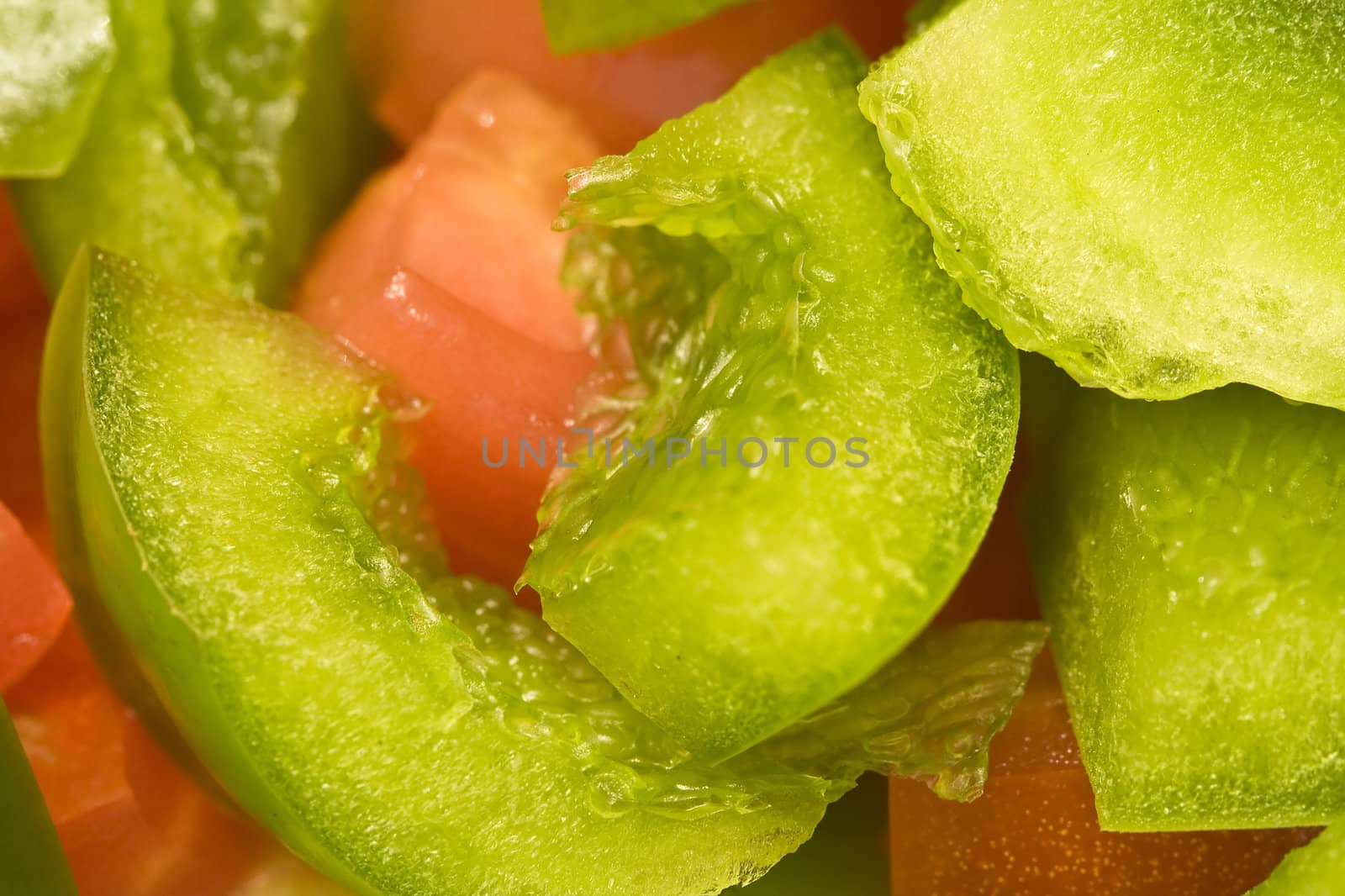 close up of red and green cut bell peppers
