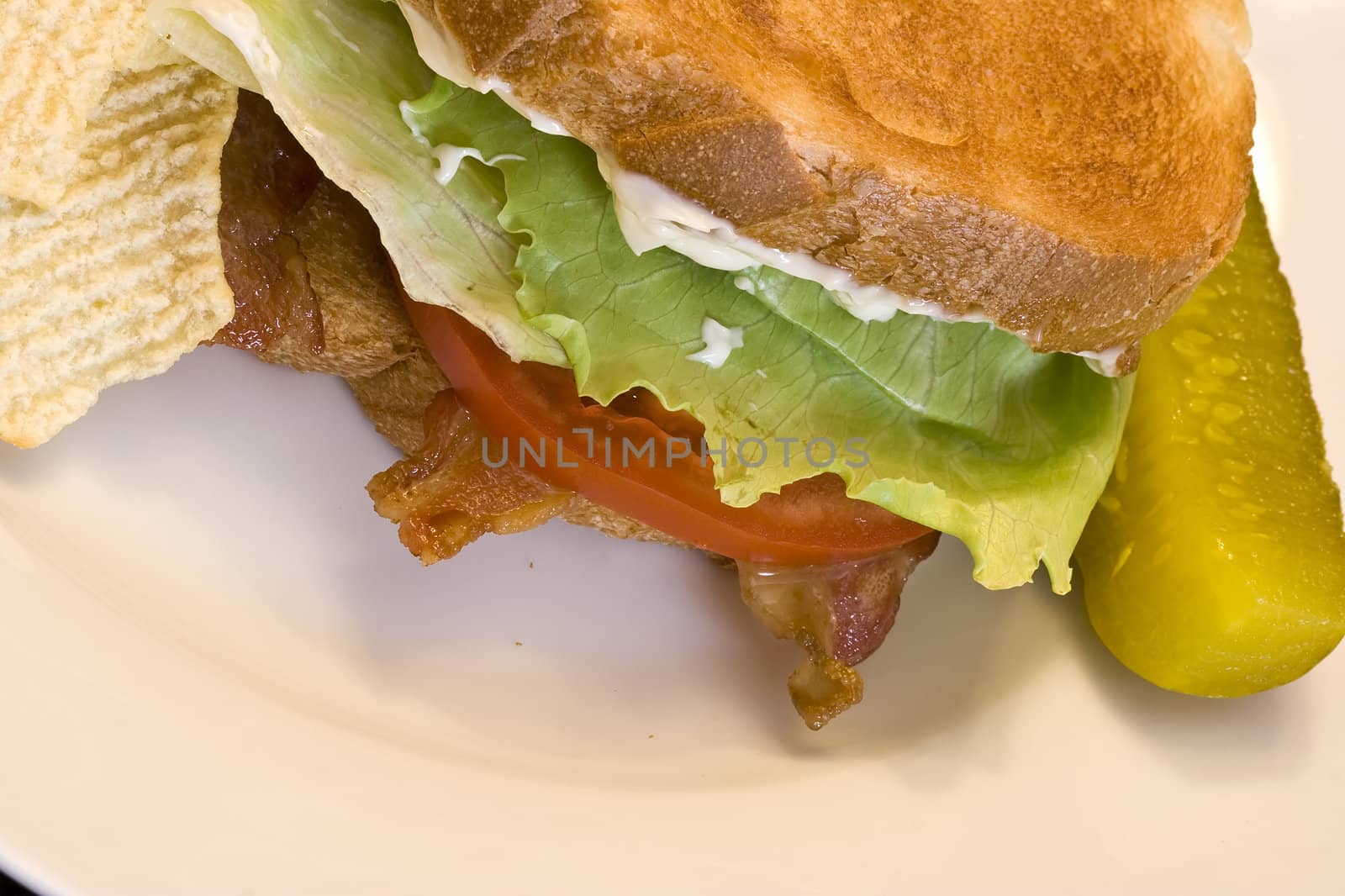 A fresh BLT sandwich with lots of bacon, fresh tomatoes,  lettuce and mayo