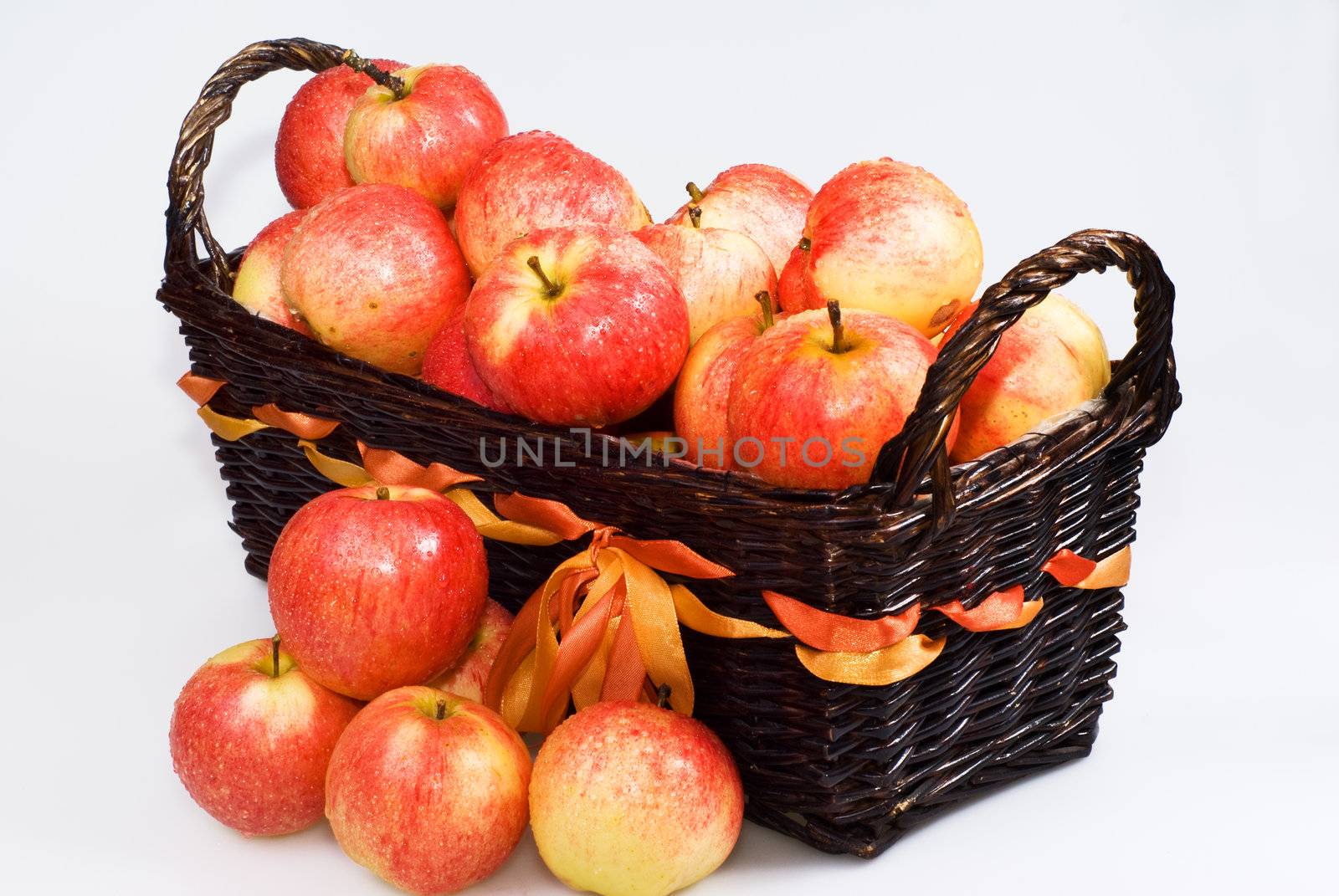 Basket with red apples on the white background