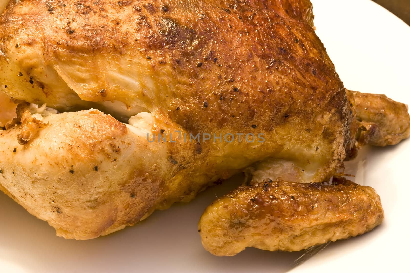 roasted chicken on a white platter cooked nicely