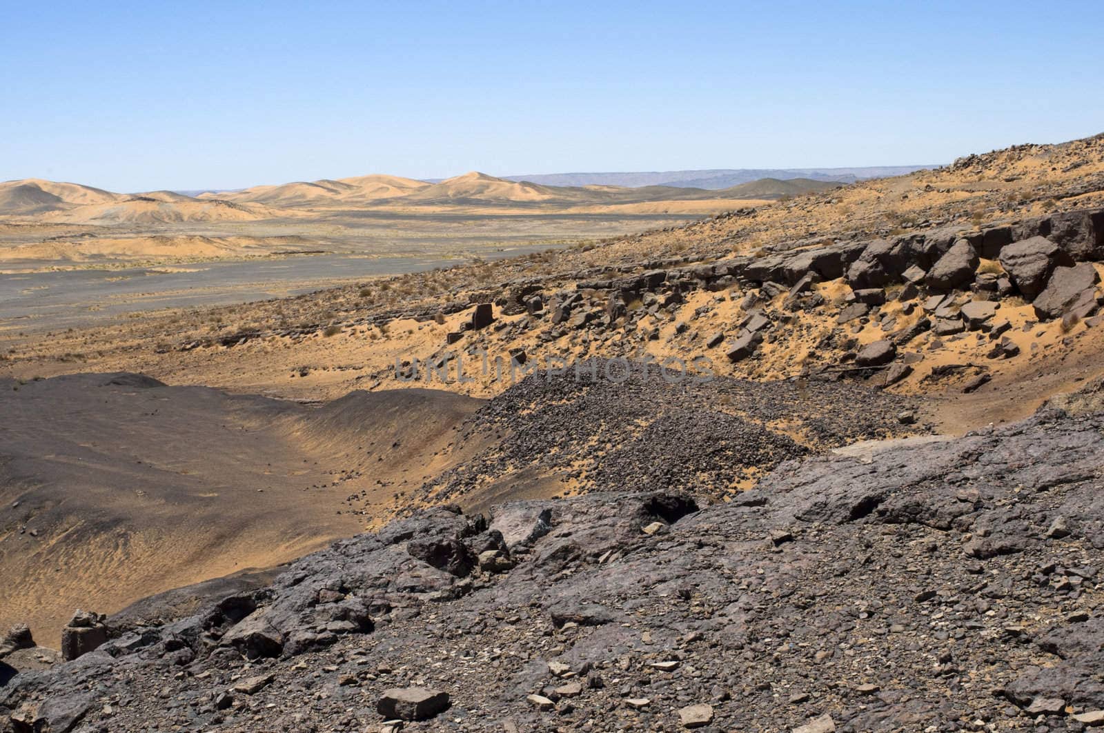 Black rock and sand dune in the Sahara desert - Best of Morocco