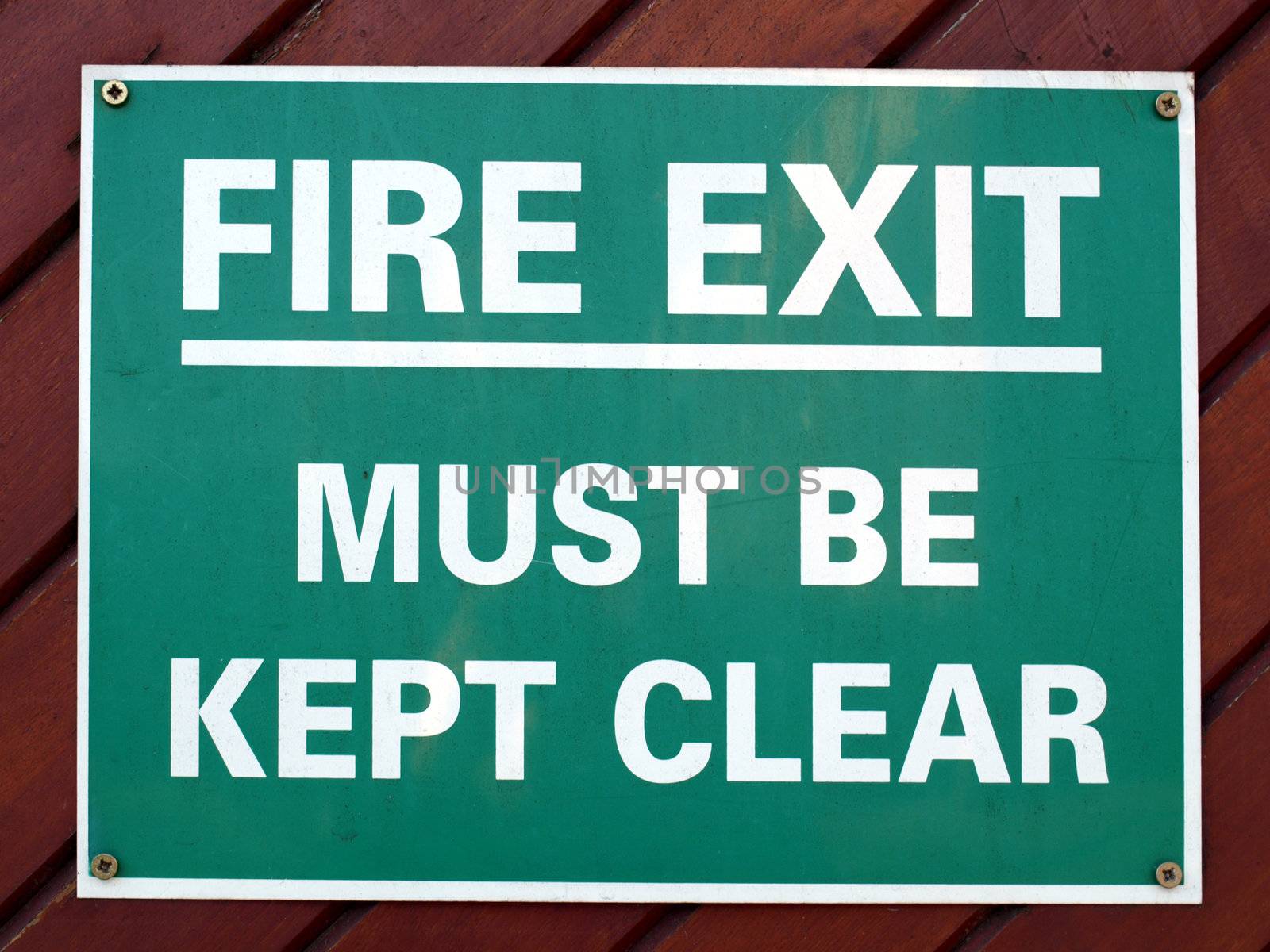 Fire exit sign with white text over green