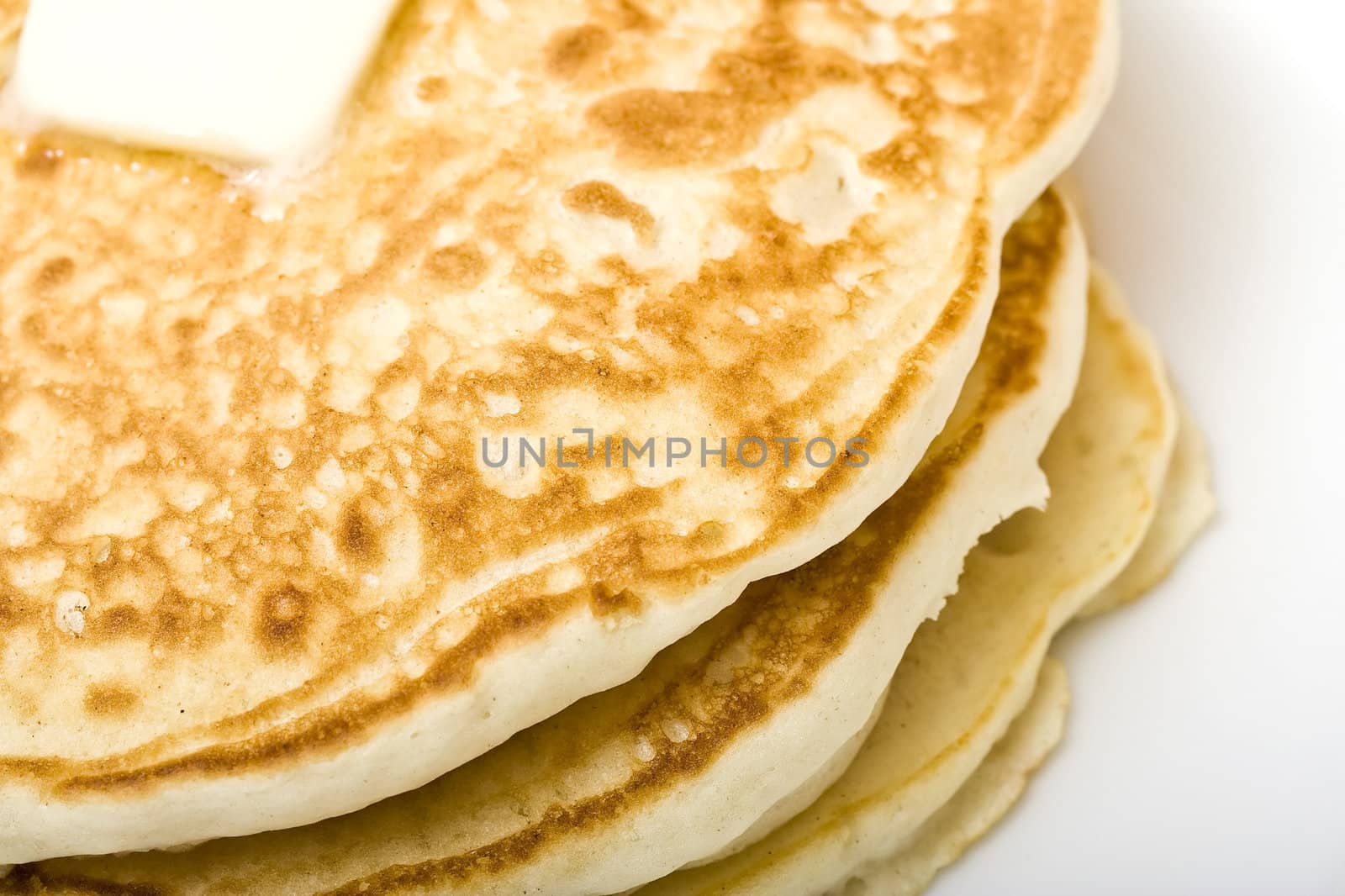 stack of buttermilk pancakes on a white plate