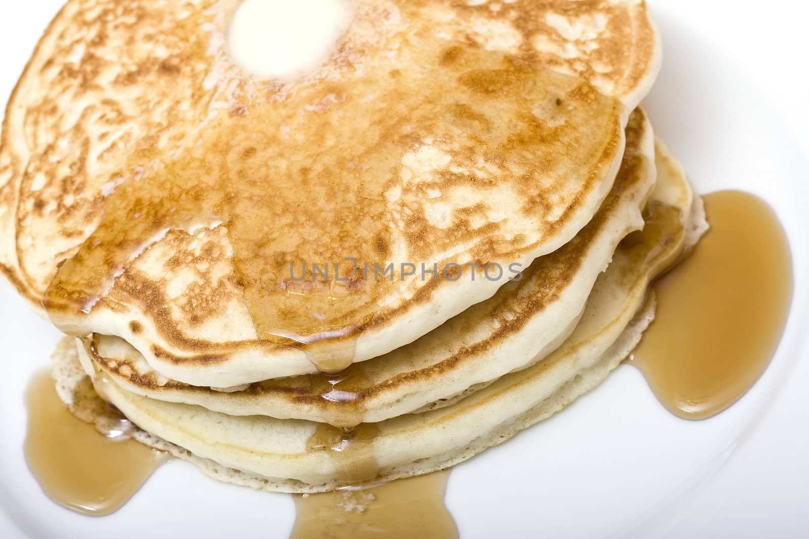 stack of buttermilk pancakes on a white plate