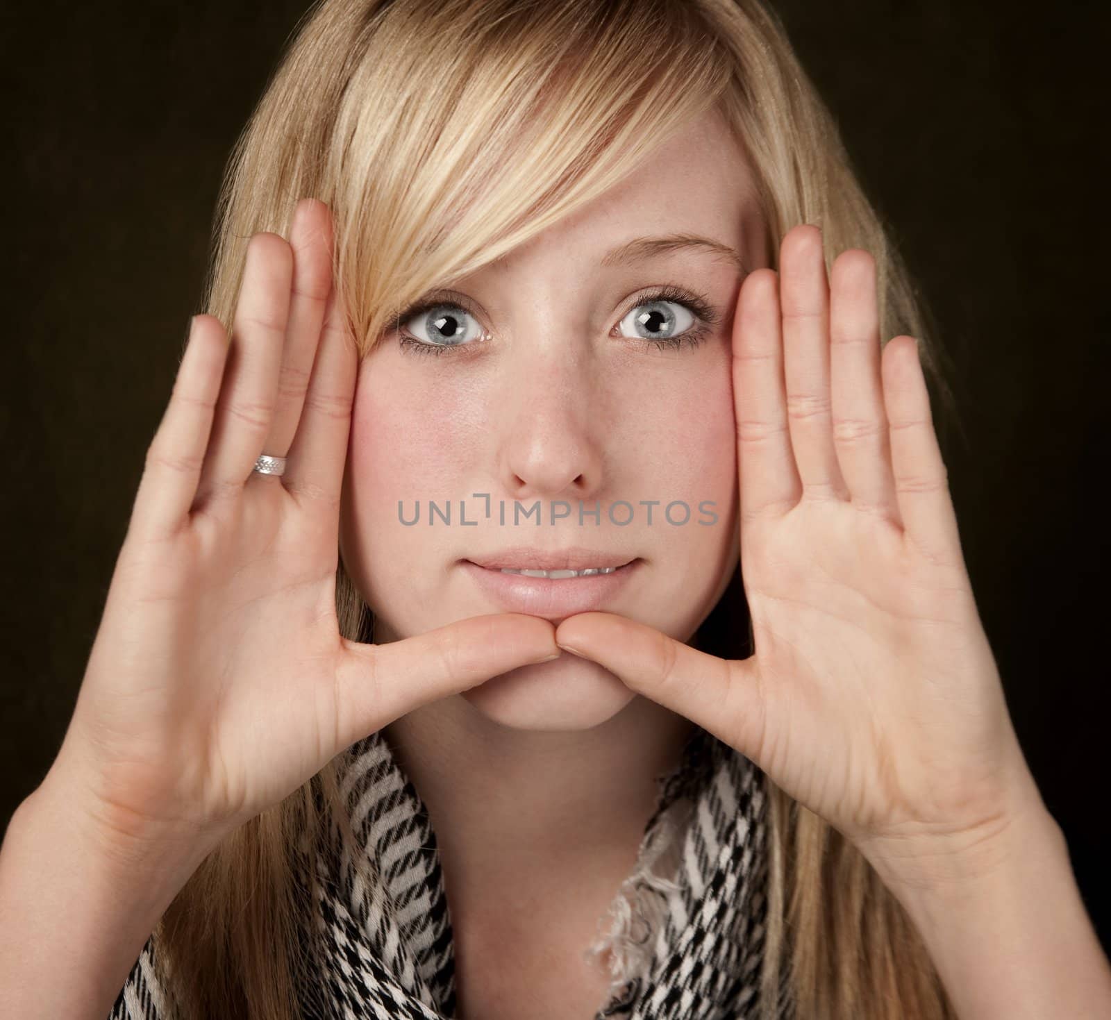 Pretty teenager framing her face with hands