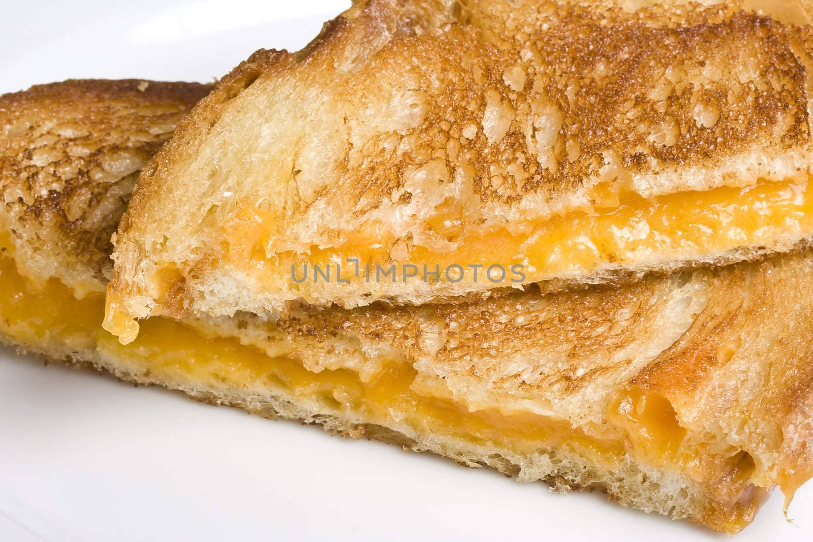 grilled cheese sandwich on a white plate shot with a macro lens