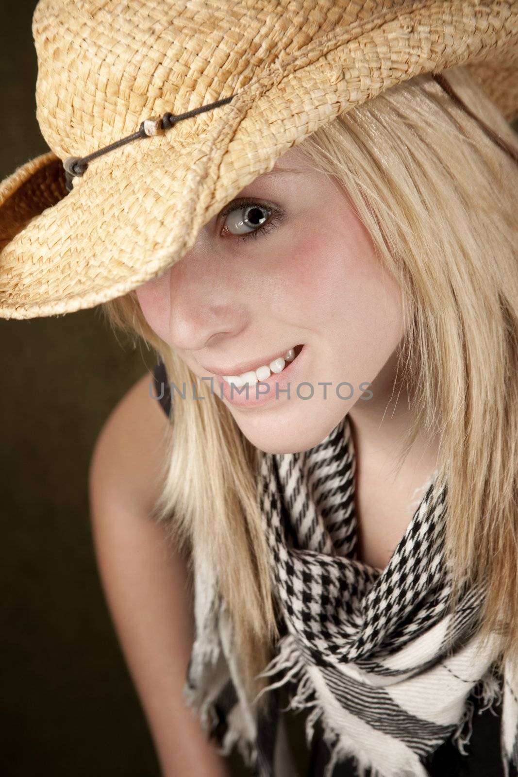 Close up of blonde girl focusing on her blue eye