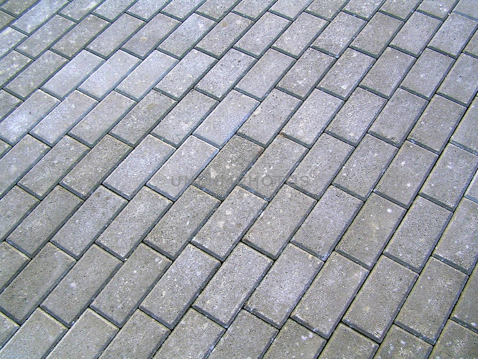 Stones roadway close up for background. Sidewalk paved by a stone.