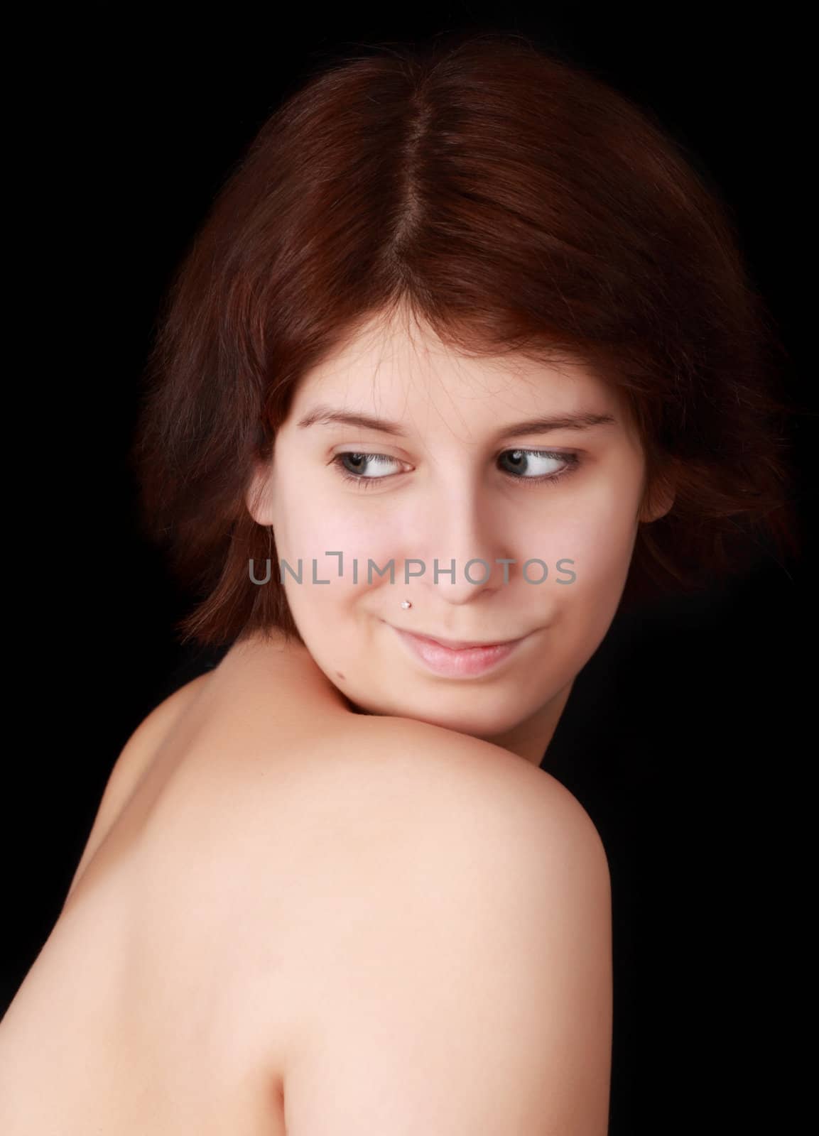 young caucasian woman, naked shoulders, black background