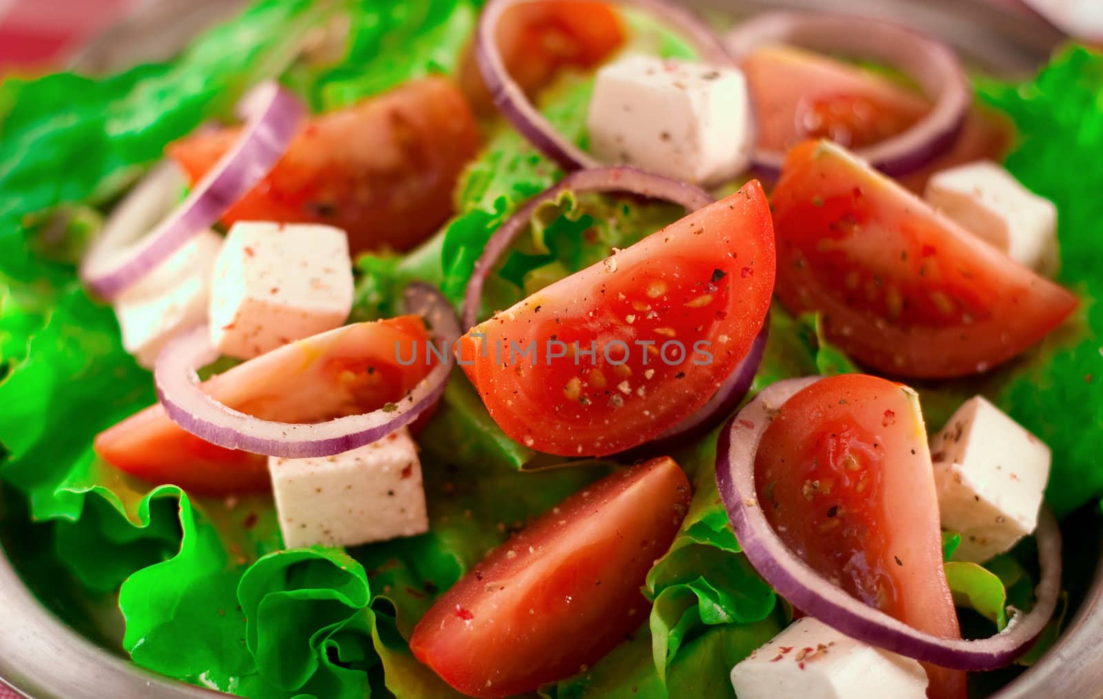 Greek salad with tomatoes cheese, herbs and onions
