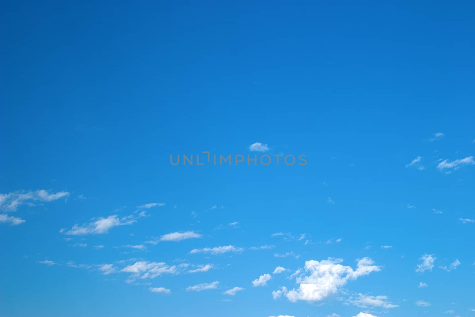 The bright blue sky with clouds