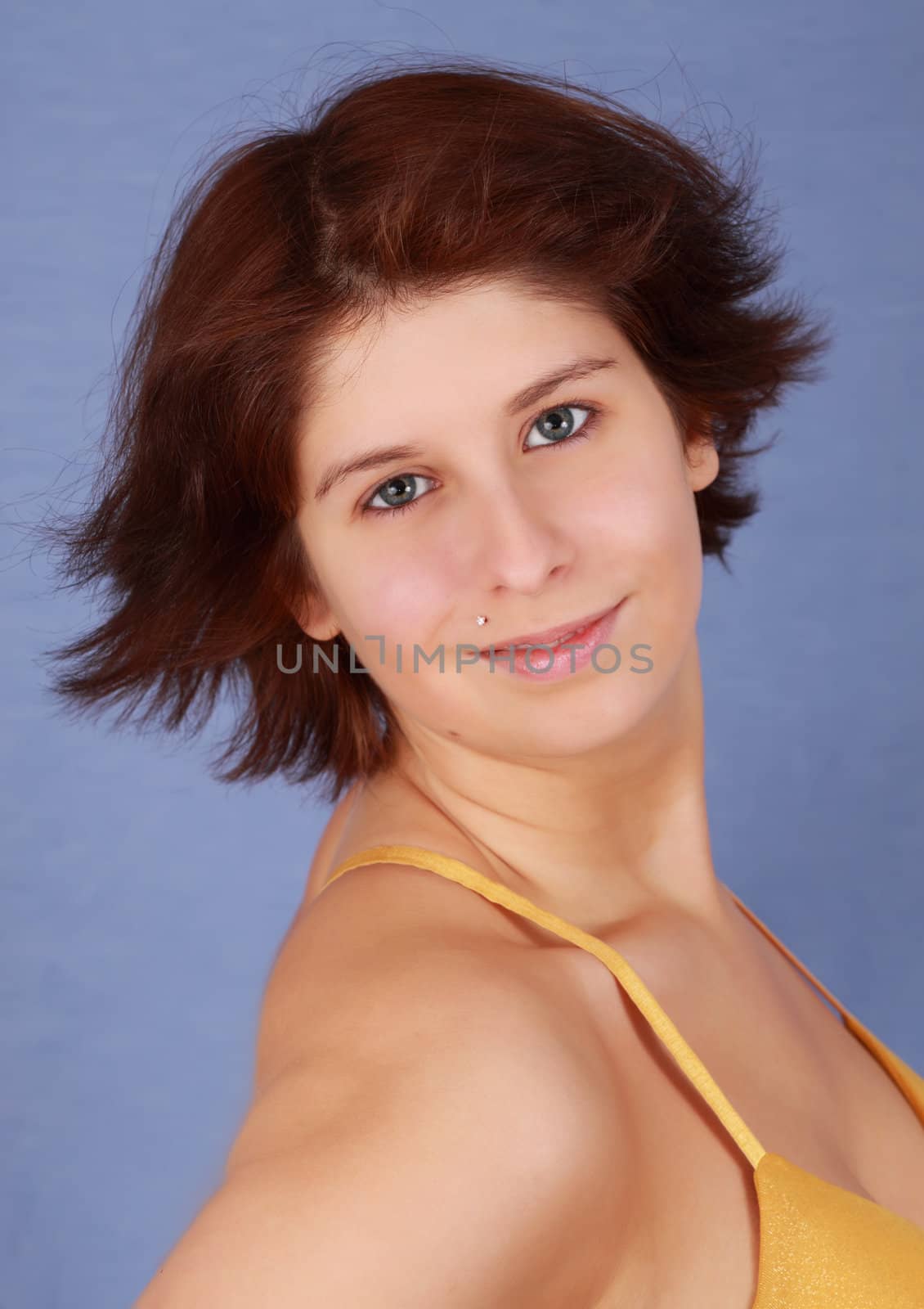portrait of a young caucasian woman, blue background