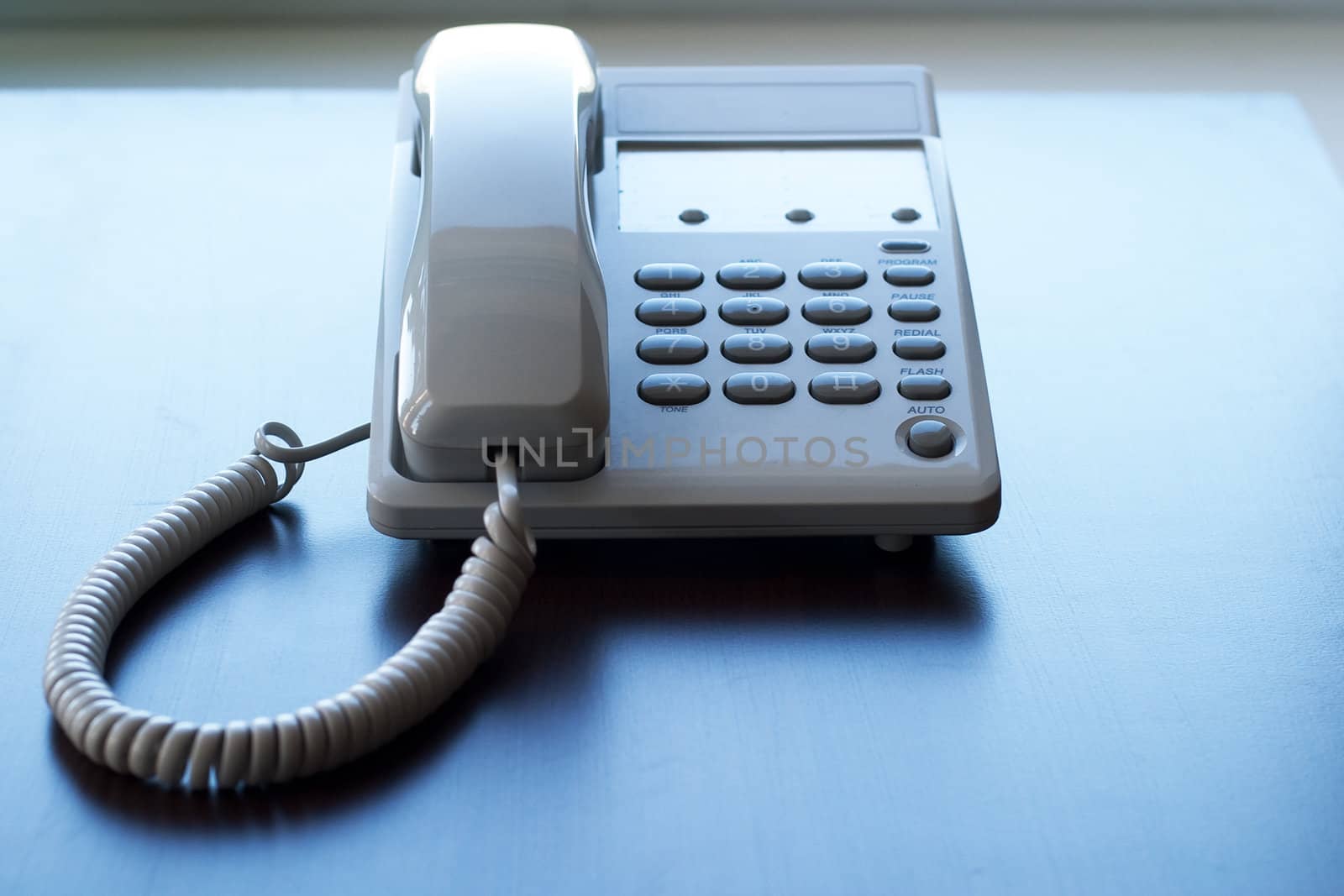 The white phone on the table. The concept of communication between people.