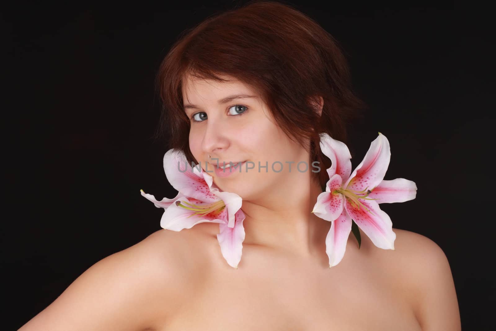 young caucasian woman, naked shoulders, black background