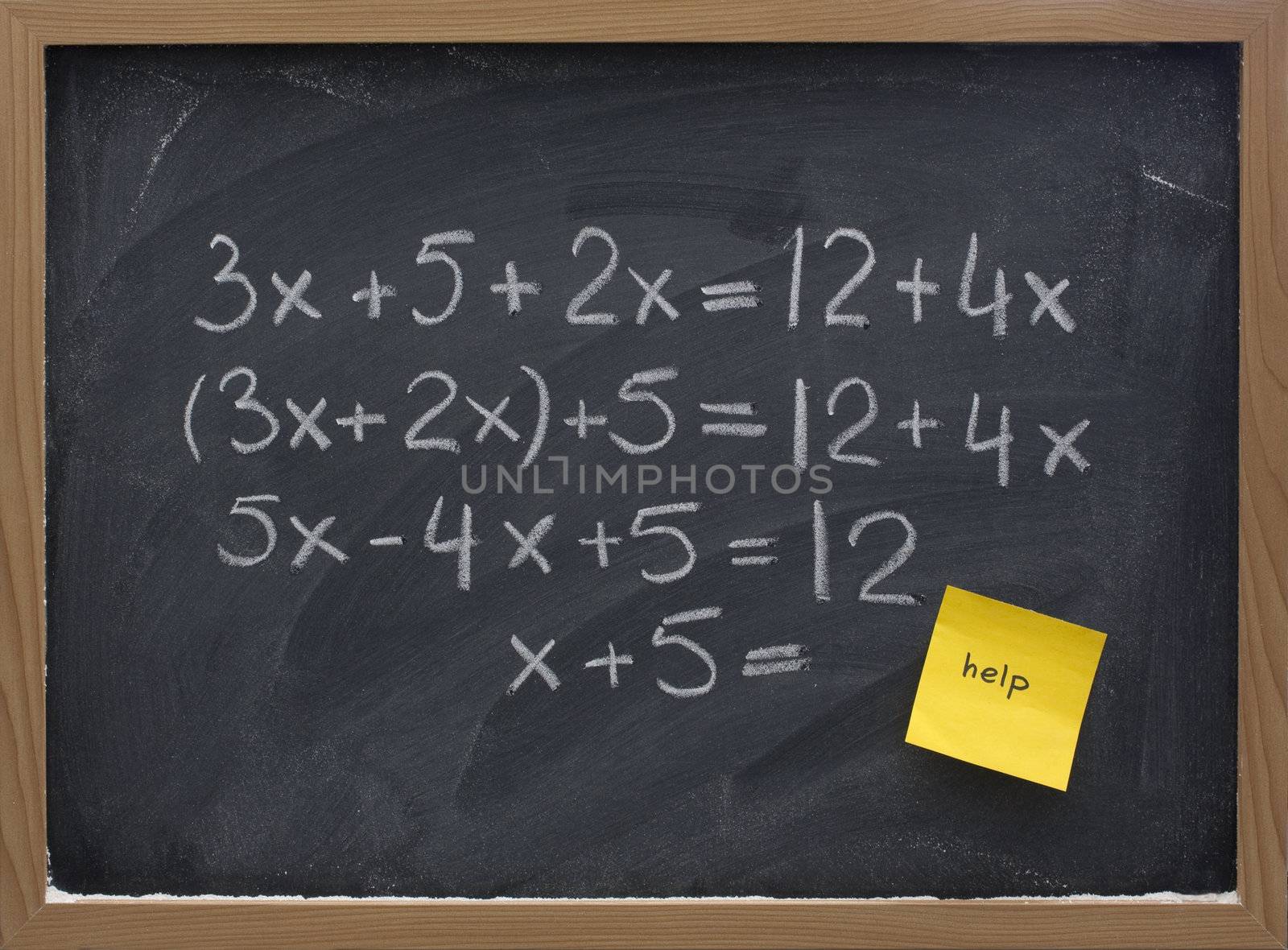simple mathematics (equation simplification) on blackboard with a yellow sticky note calling for help