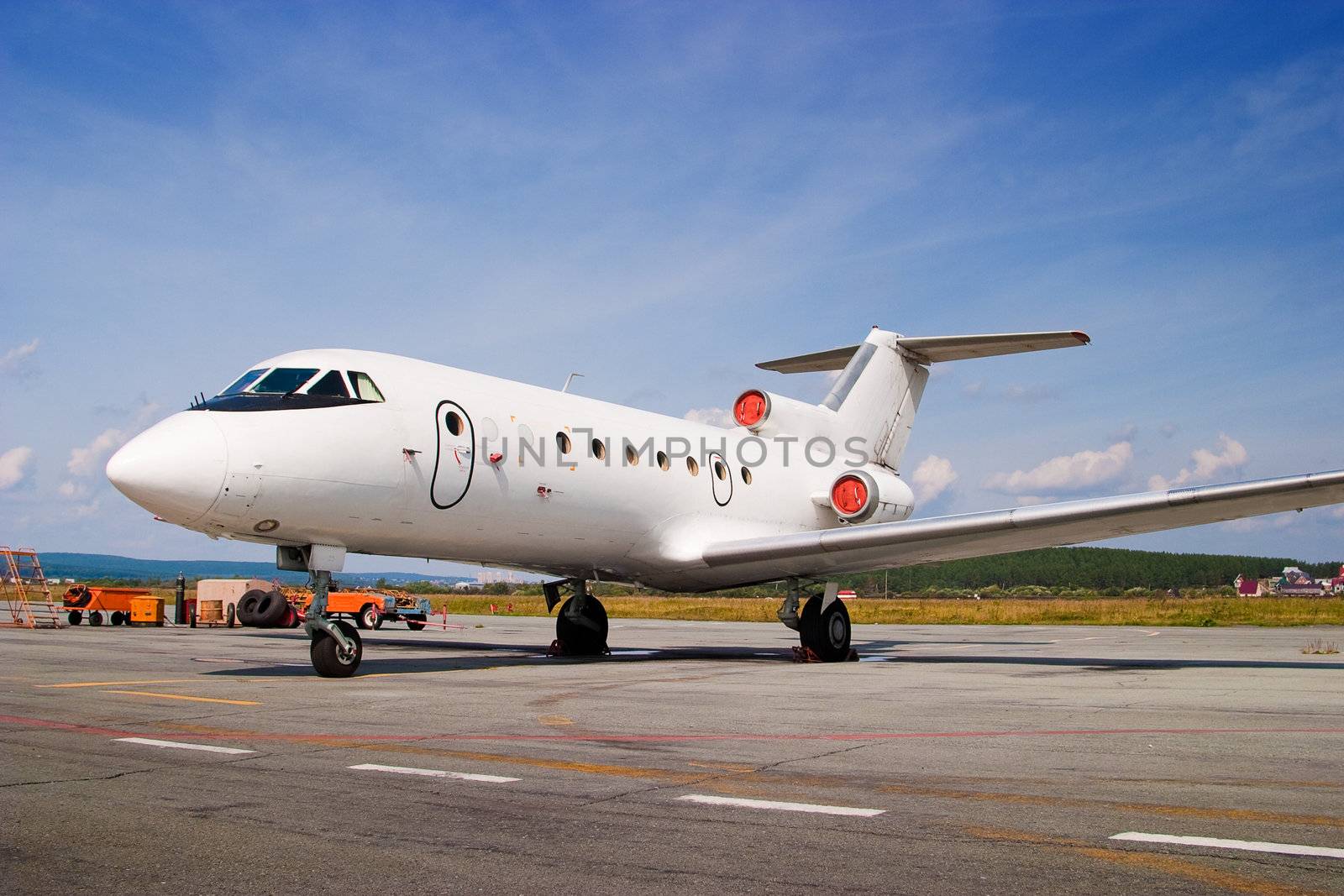 Airplane parked at airport. Small business jet.