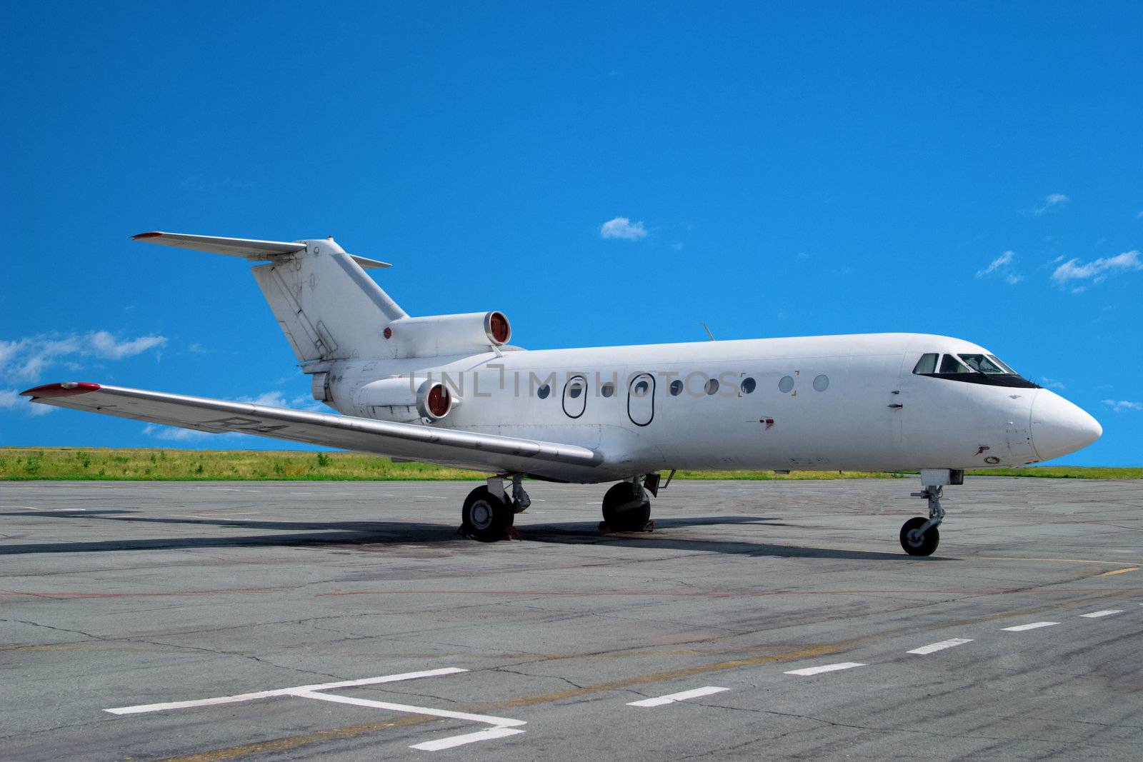 Airplane parked at airport. Small business jet.