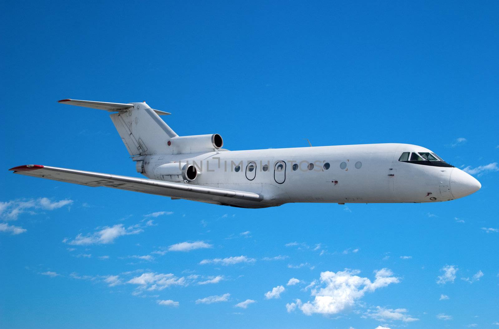 Airplane flying against the blue sky