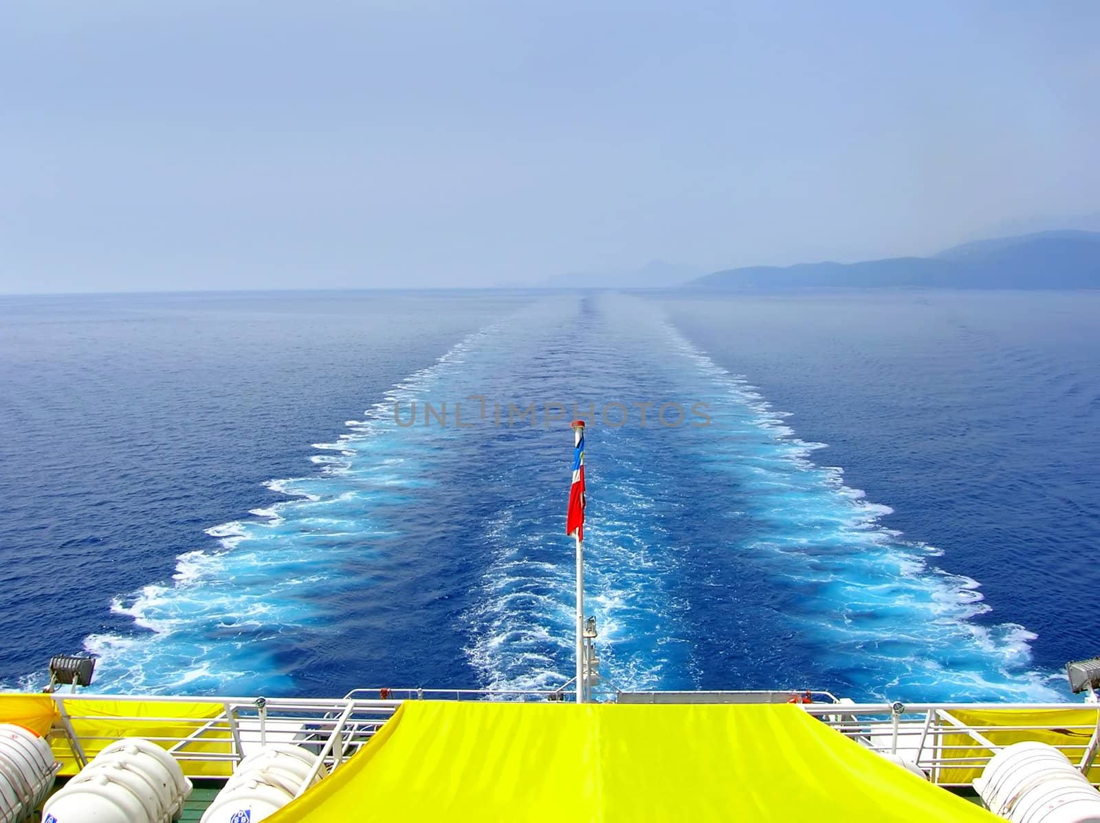 water foam trace behind large passenger ship on adriatic sea