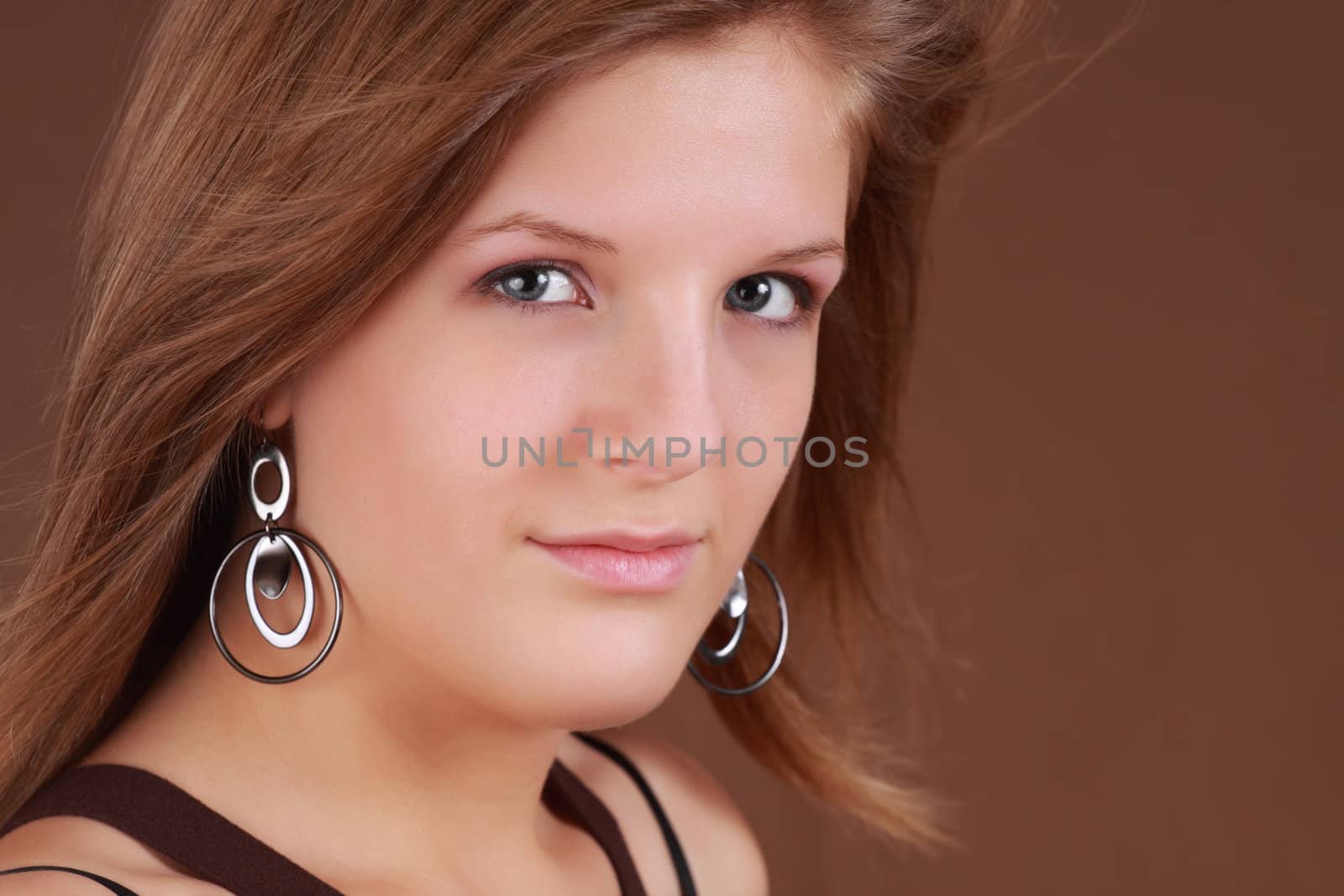 portrait of a young caucasian woman, brown background