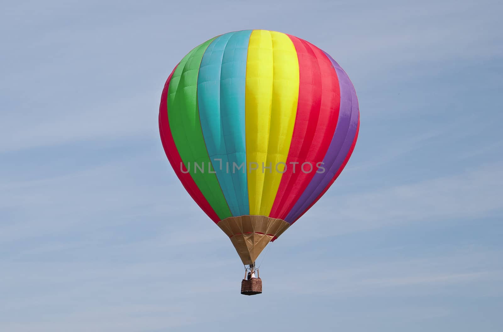 Varicoloured balloon flies on a background sky. People are unrecognizable